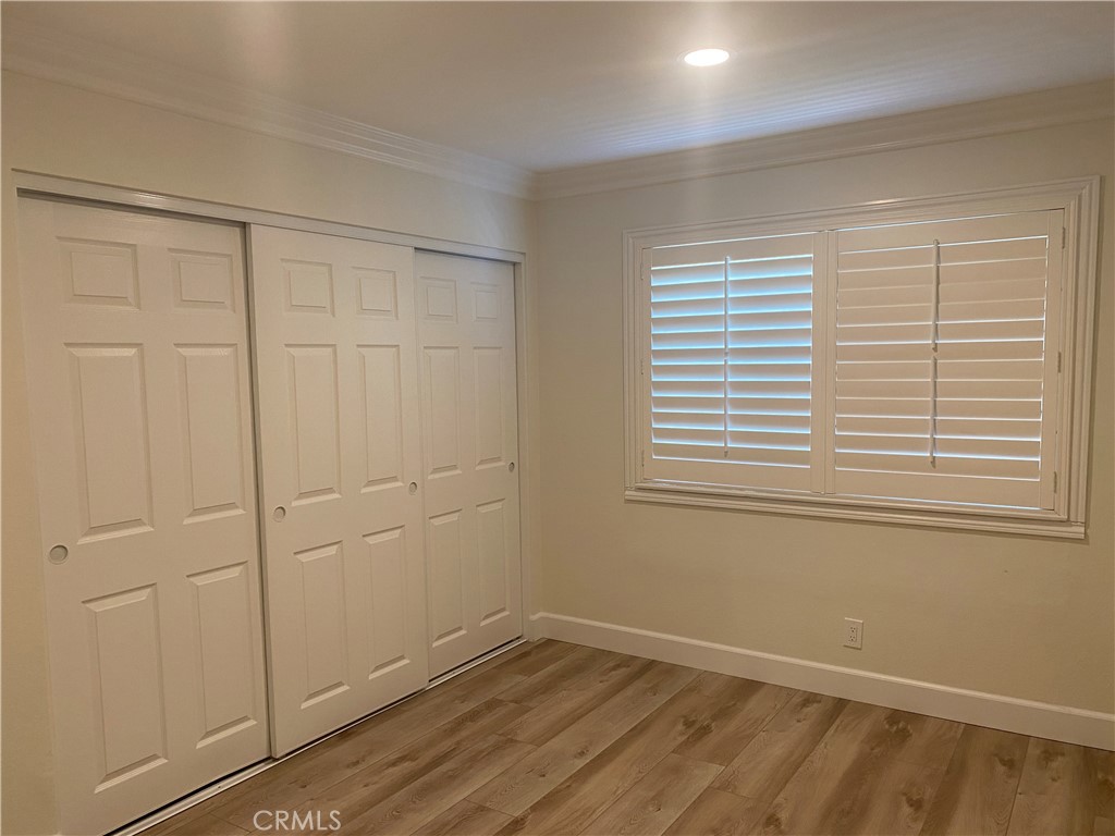 430 Buttonwood Drive Brea, CA 92821 - Photo 14 of 27 a view of an empty room with wooden floor and a window