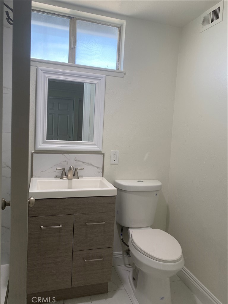 430 Buttonwood Drive Brea, CA 92821 - Photo 19 of 27 a bathroom with a toilet a sink a vanity and mirror