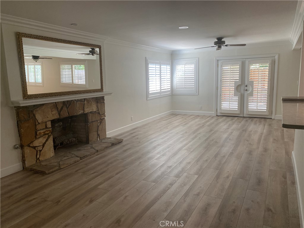 430 Buttonwood Drive Brea, CA 92821 - Photo 5 of 27 an empty room with wooden floor fireplace and windows