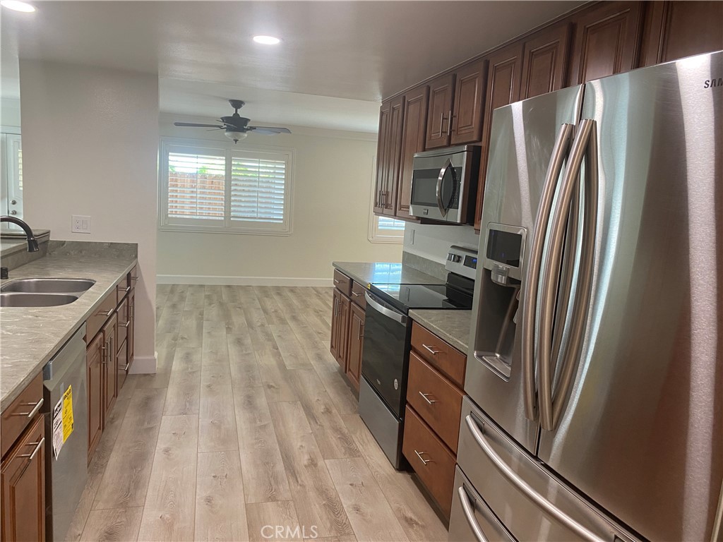 430 Buttonwood Drive Brea, CA 92821 - Photo 7 of 27 a kitchen with stainless steel appliances granite countertop a refrigerator a stove a sink and a stove