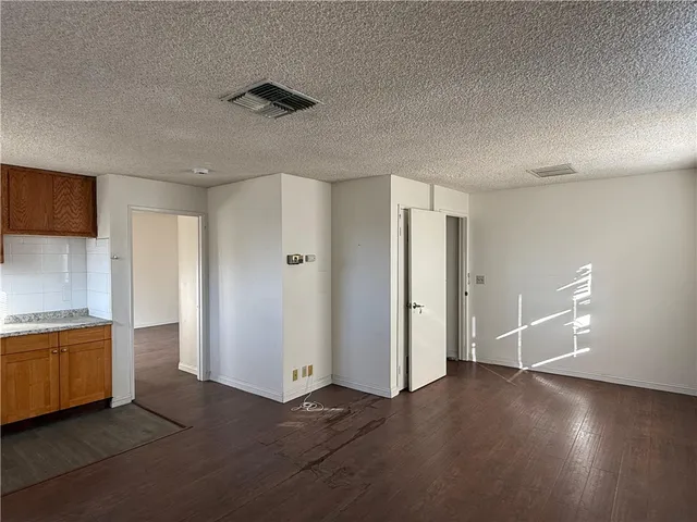 a view of a kitchen with a sink and a refrigerator