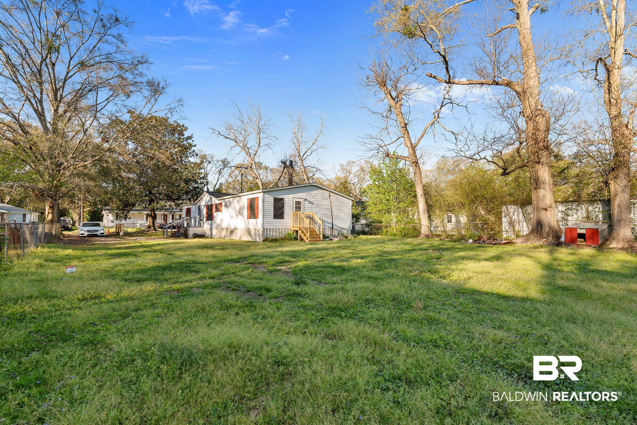 7695 Bermuda Drive Semmes, AL 36575 - Photo 5 of 27 View of yard with fence and entry steps