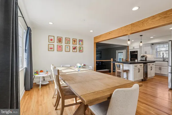 a dining room with furniture and wooden floor
