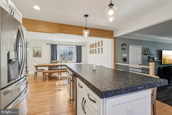 a kitchen with stainless steel appliances granite countertop stove top oven and refrigerator