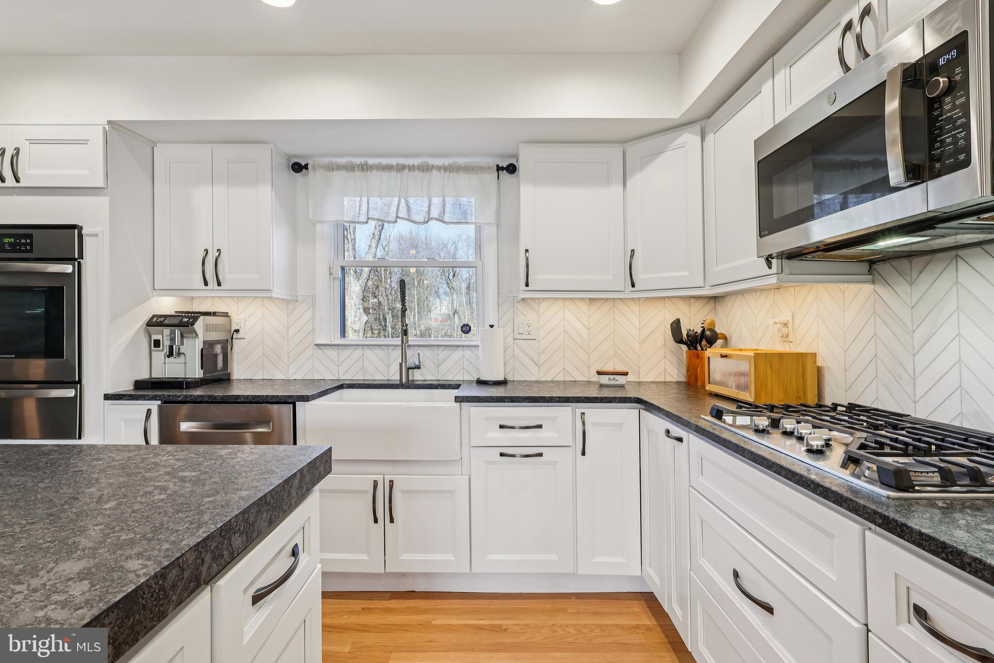 20 Corey Drive Ewing, NJ 08628 - Photo 17 of 52 a kitchen with stainless steel appliances granite countertop a stove a sink and a microwave