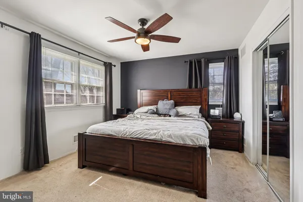a bedroom with a bed and a large window