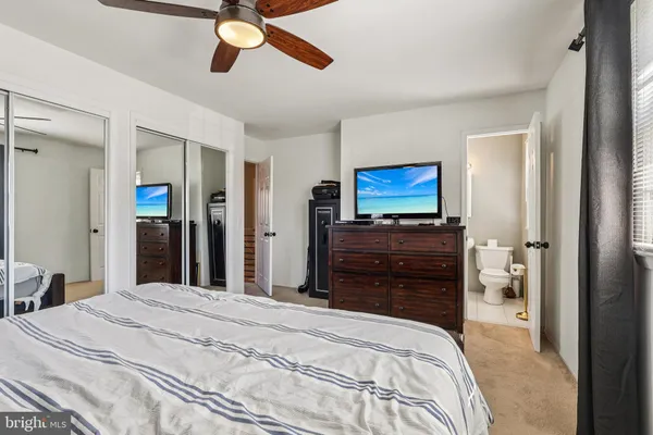 a bedroom with a bed and a mirror