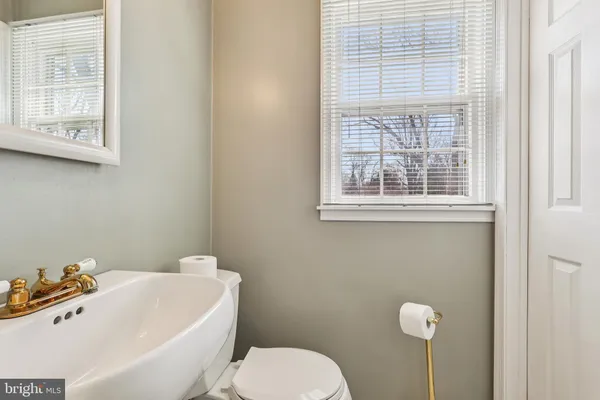 a white toilet sitting next to a bathroom sink