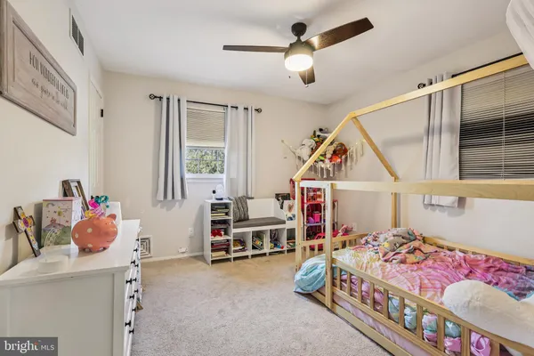 a bedroom with furniture and baby crib