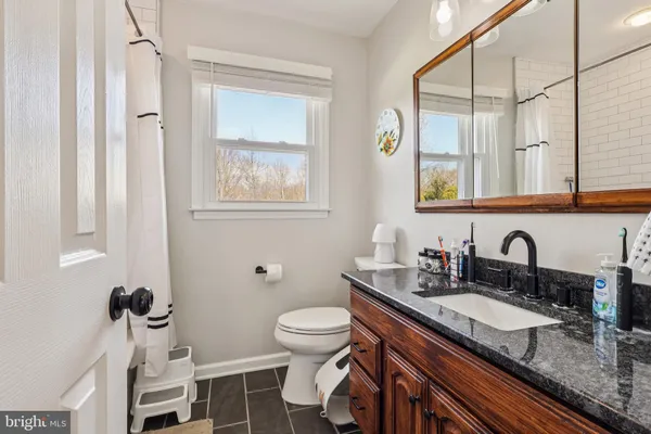 a bathroom with sinks granite countertop a sink and a mirror