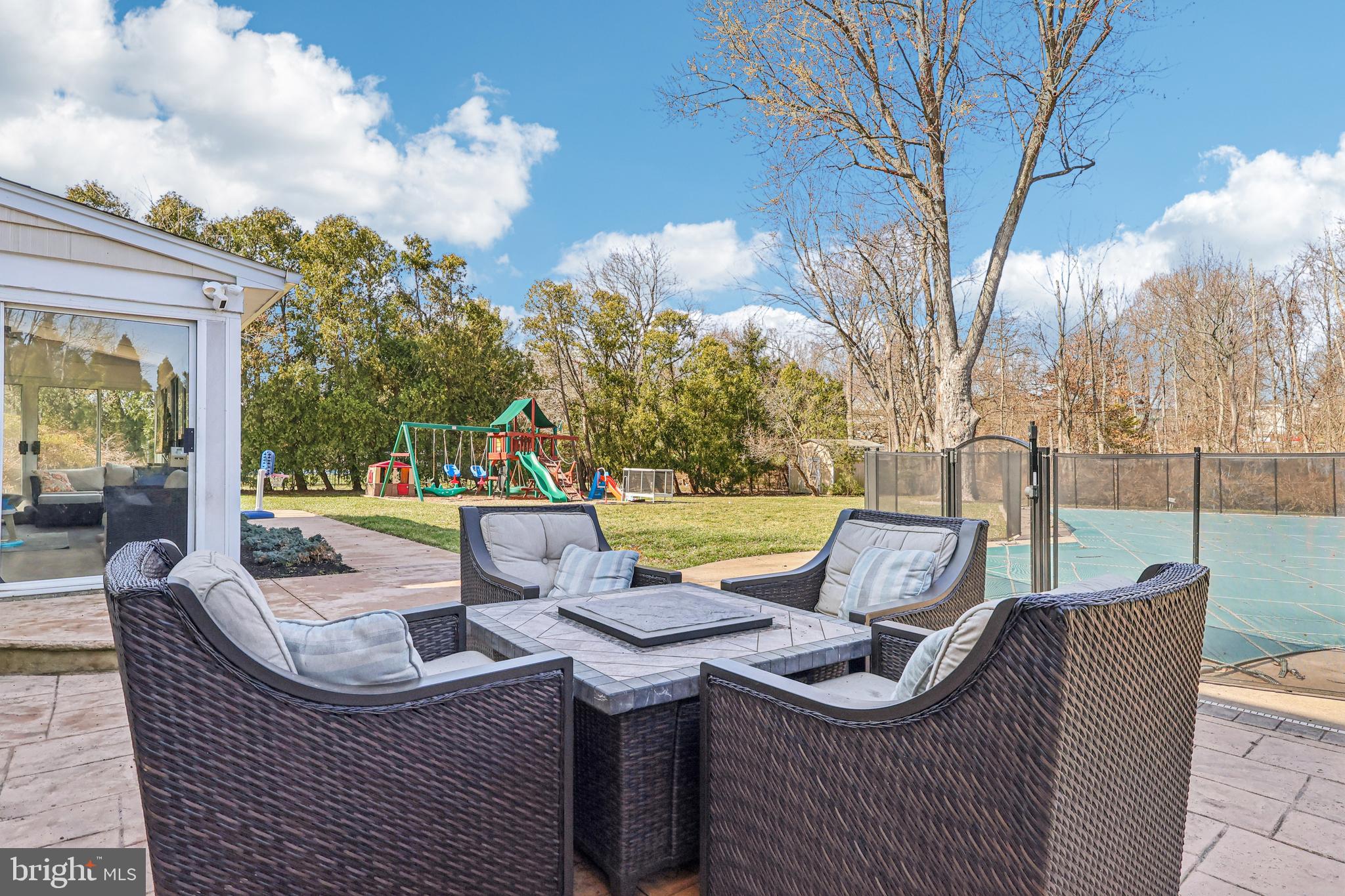 20 Corey Drive Ewing, NJ 08628 - Photo 43 of 52 a view of a patio with couches chairs and a fire pit with two large trees