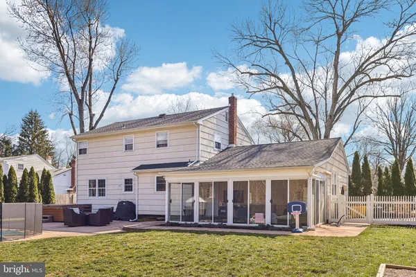 front view of a house with a large tree