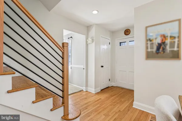 a view of a hallway with wooden floor and staircase