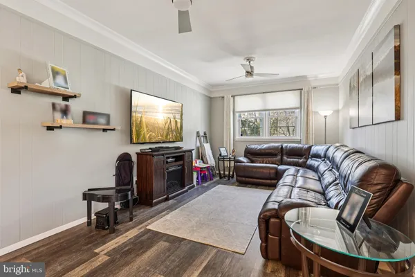 a living room with furniture tv and a window