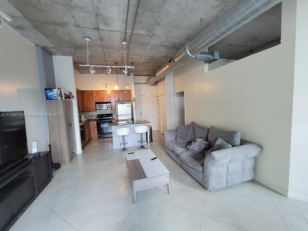 2001 Biscayne Boulevard, Unit 3206 Miami, FL 33137 - Photo 3 of 16 a living room with furniture and a flat screen tv