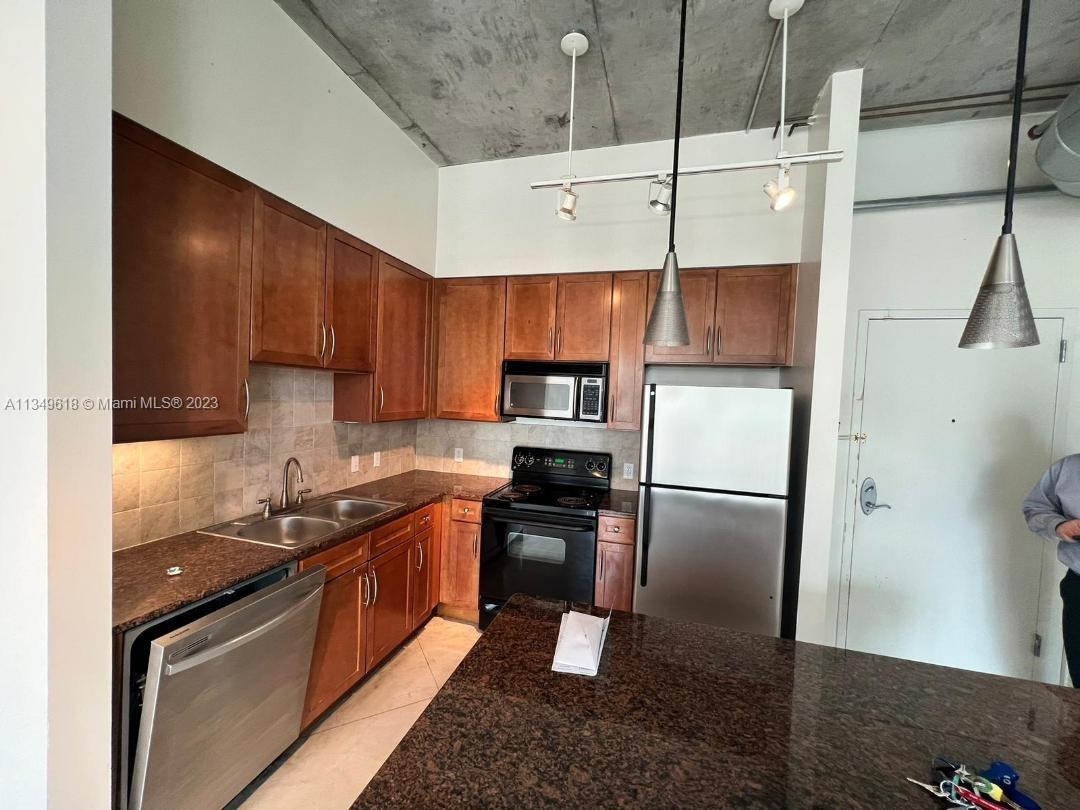 2001 Biscayne Boulevard, Unit 3206 Miami, FL 33137 - Photo 5 of 16 a kitchen with stainless steel appliances granite countertop a refrigerator a stove and a sink
