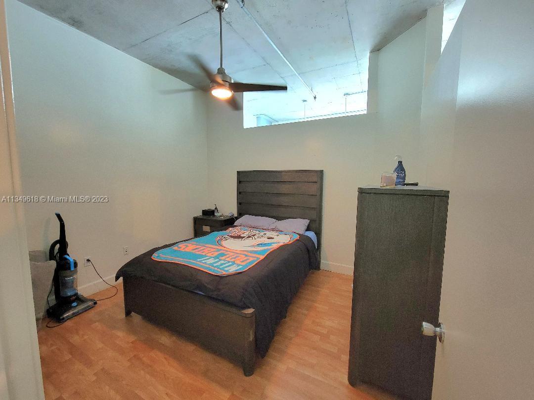 2001 Biscayne Boulevard, Unit 3206 Miami, FL 33137 - Photo 6 of 16 a bedroom with a bed and a chandelier