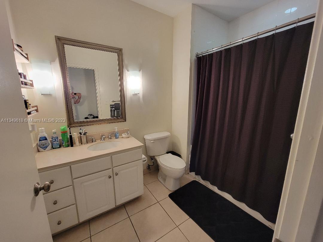 2001 Biscayne Boulevard, Unit 3206 Miami, FL 33137 - Photo 7 of 16 a bathroom with a toilet sink and mirror