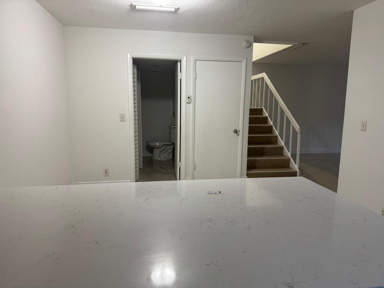 4702 Waterview Circle Palm Springs, FL 33461 - Photo 18 of 22 a view of an empty room with stairs
