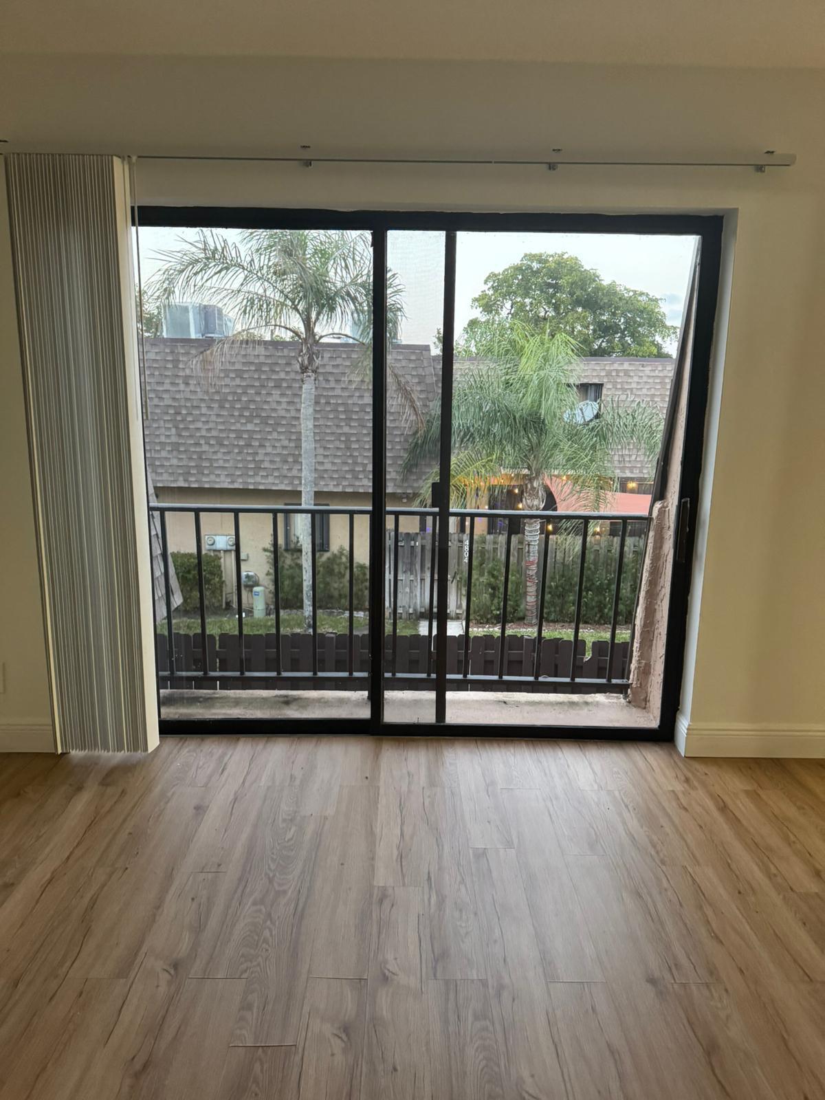 4702 Waterview Circle Palm Springs, FL 33461 - Photo 2 of 22 a view of empty room with wooden floor and fan