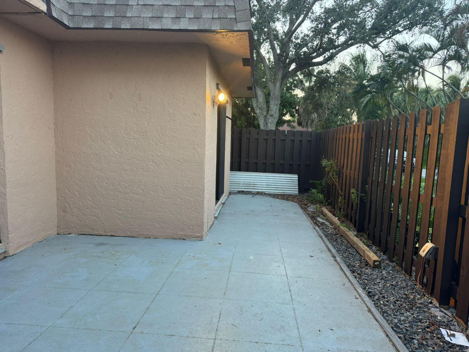 4702 Waterview Circle Palm Springs, FL 33461 - Photo 21 of 22 a view of backyard with wooden fence and trees