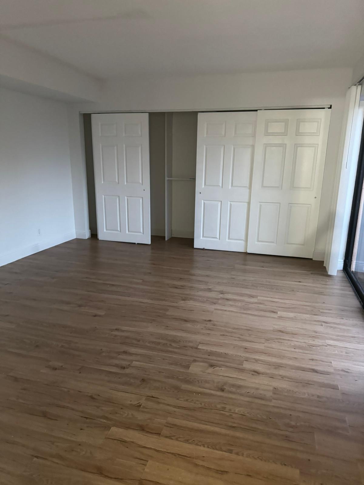 4702 Waterview Circle Palm Springs, FL 33461 - Photo 4 of 22 a view of an empty room with wooden floor