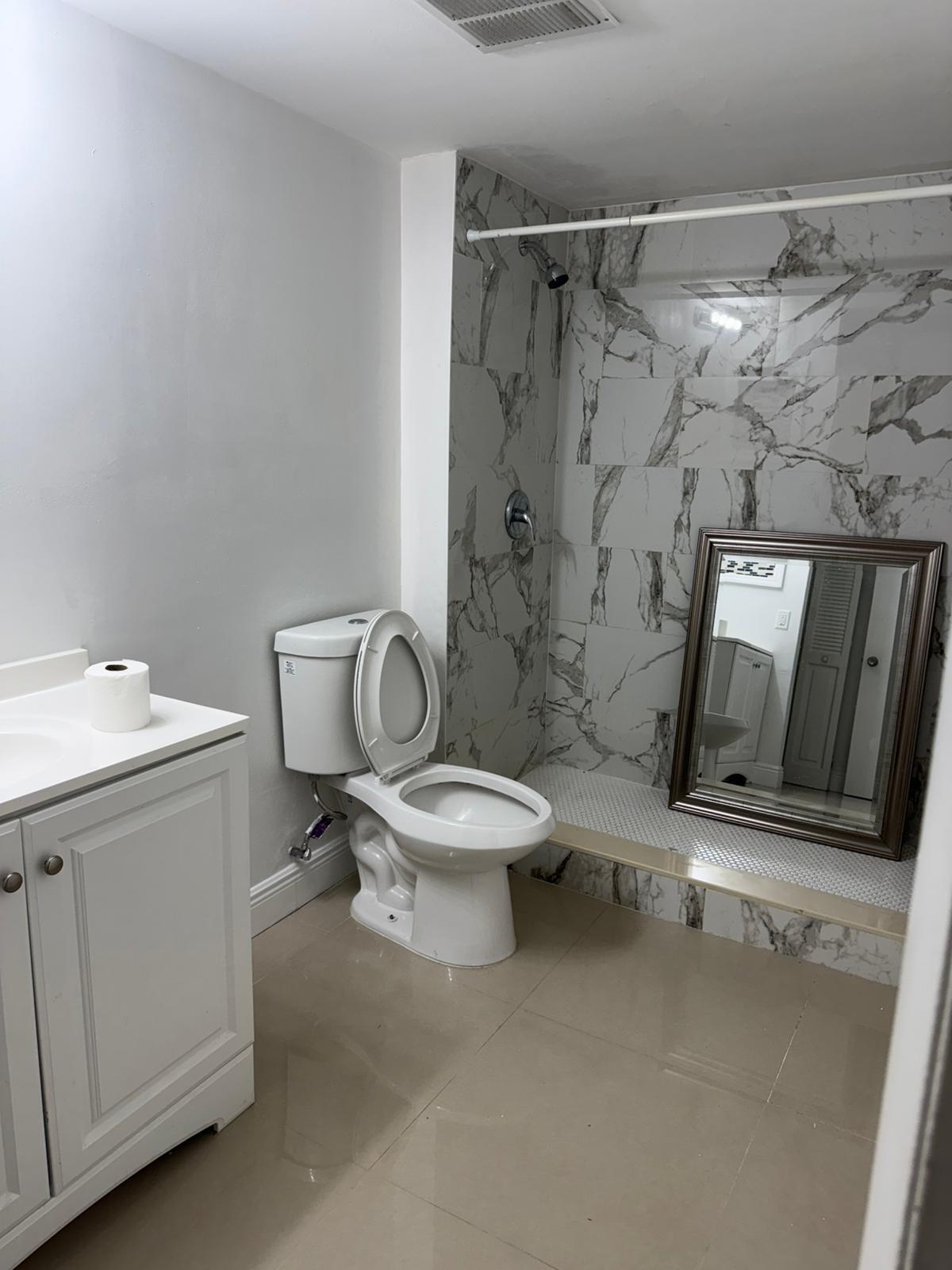 4702 Waterview Circle Palm Springs, FL 33461 - Photo 8 of 22 a white toilet sitting next to a bathroom sink