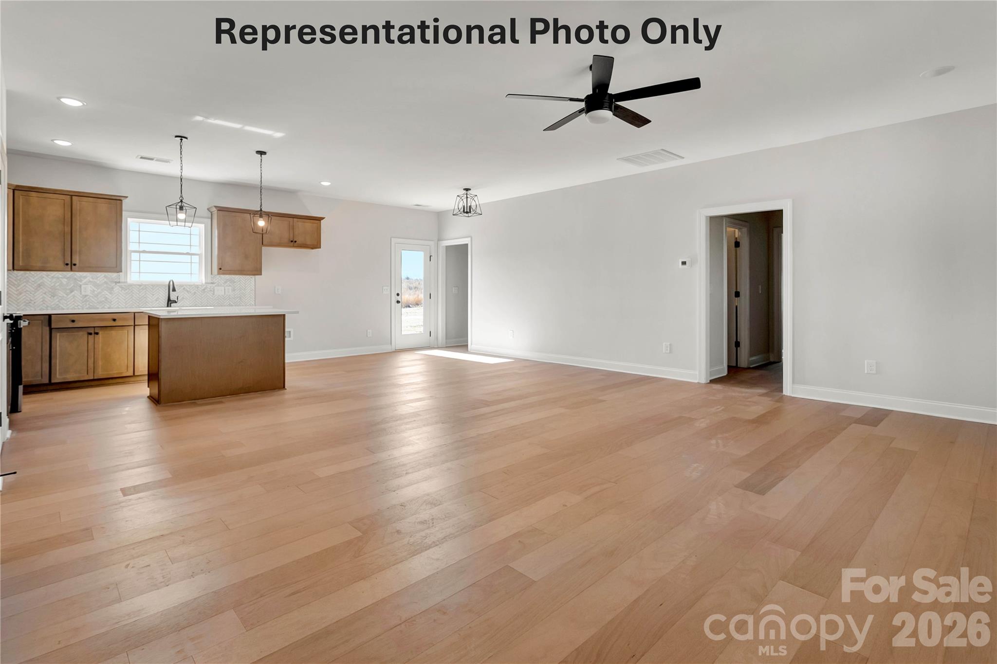 265 Bob Friday Road Dallas, NC 28034 - Photo 8 of 13 a view of kitchen with stainless steel appliances granite countertop a stove top oven a sink a refrigerator white cabinets and wooden floor