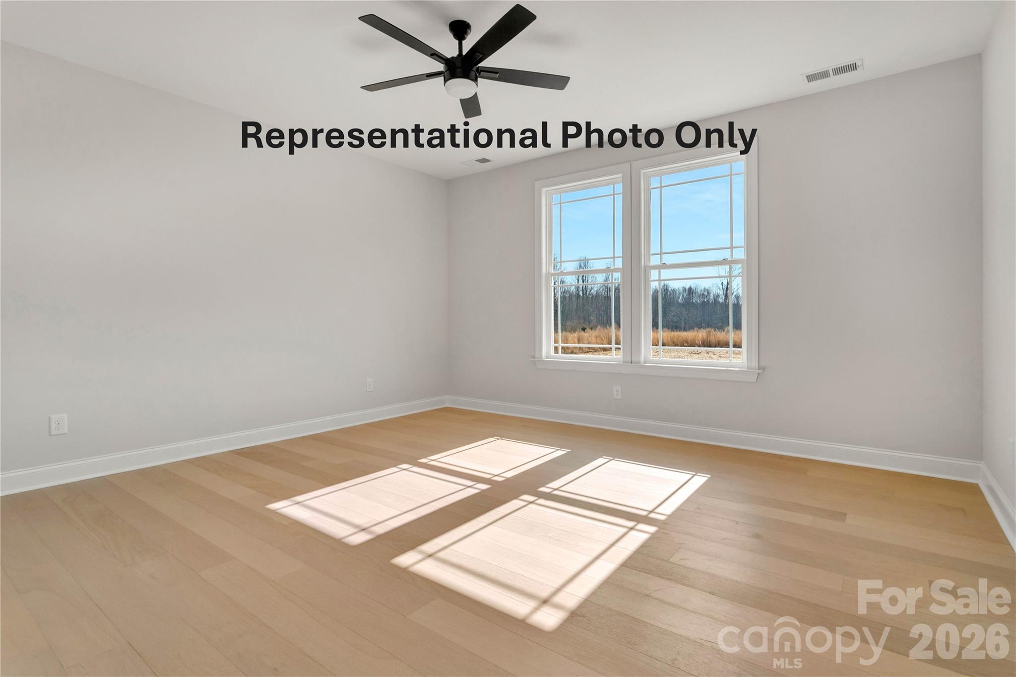265 Bob Friday Road Dallas, NC 28034 - Photo 10 of 13 a view of a bedroom with wooden floor and windows