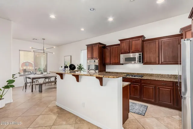 a large white kitchen with lots of appliances a sink a counter top space and cabinets