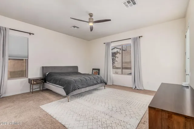 a bedroom with a large bed and a window