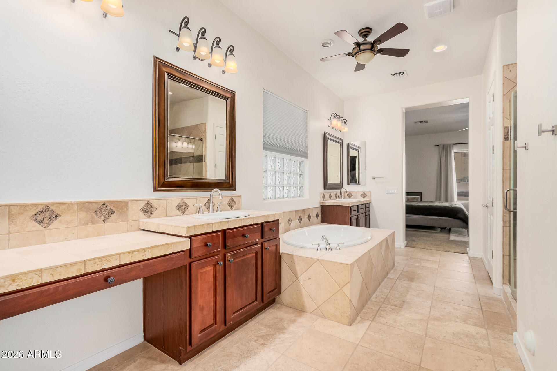 5606 West Desperado Way Phoenix, AZ 85083 - Photo 22 of 43 a spacious bathroom with a sink a mirror and a bathtub