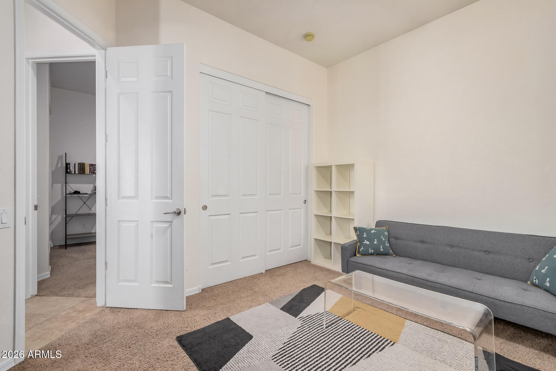 5606 West Desperado Way Phoenix, AZ 85083 - Photo 26 of 43 a living room with a couch and a walk in closet with wooden floor