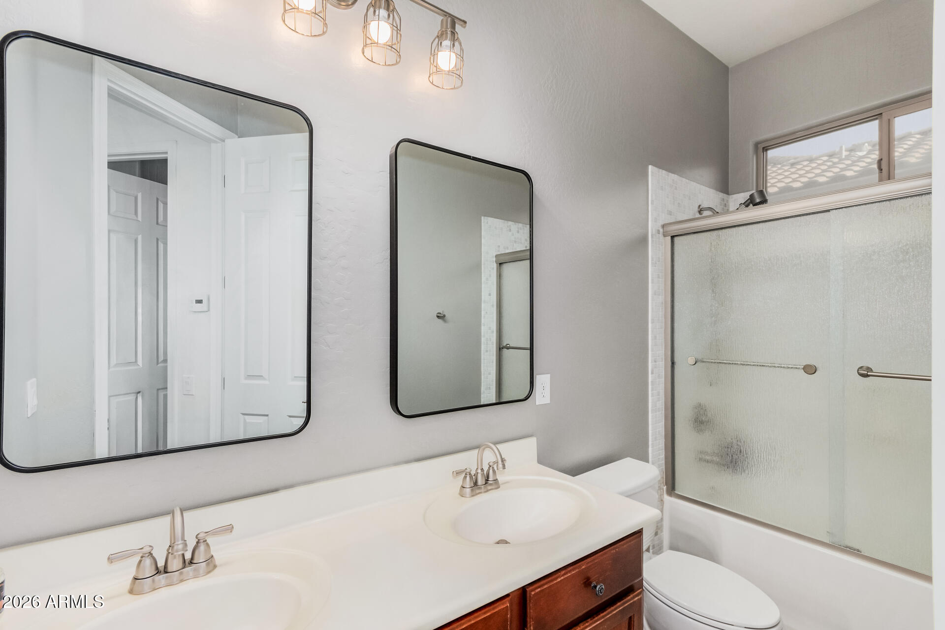 5606 West Desperado Way Phoenix, AZ 85083 - Photo 30 of 43 a bathroom with double vanity sink and mirror