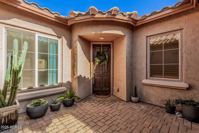 a view of a house with potted plants