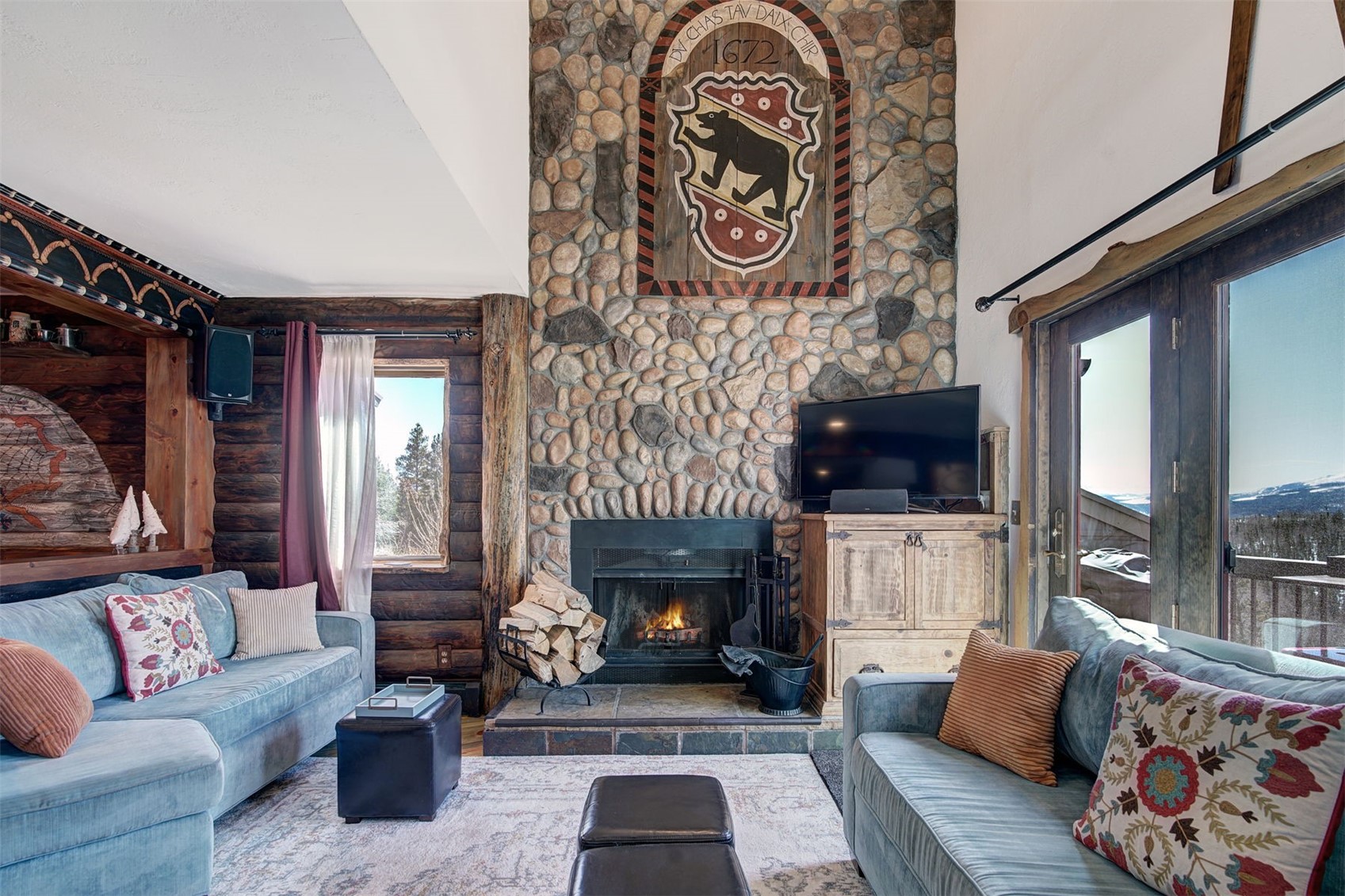 9460 Ryan Gulch Road, Unit 9460 Silverthorne, CO 80498 - Photo 8 of 39 a living room with furniture and a fireplace