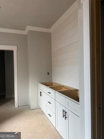 a kitchen with granite countertop white cabinets and sink