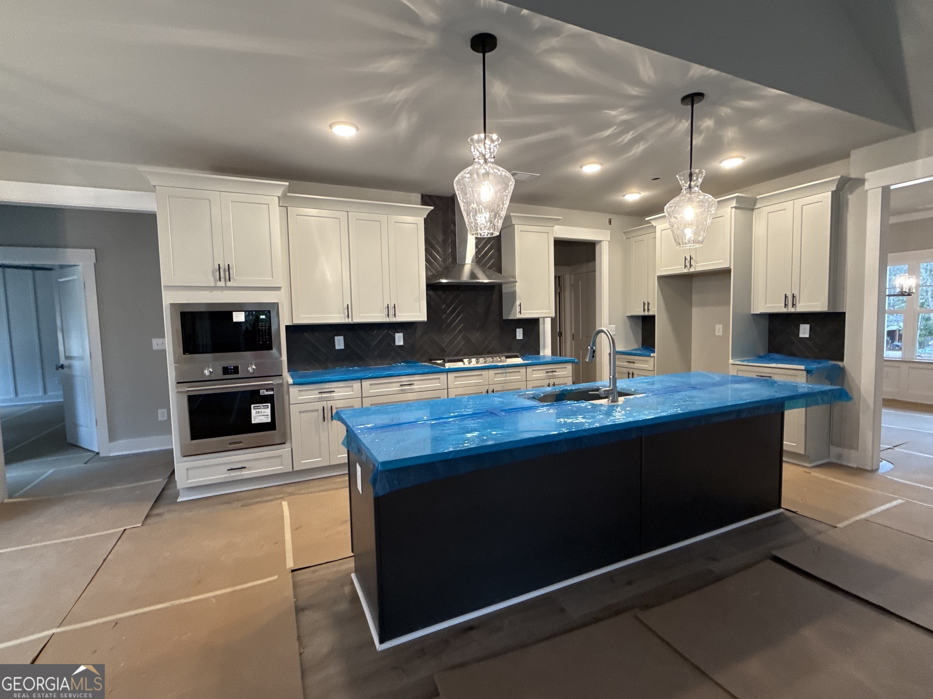 396 Tanners Bridge Road Bethlehem, GA 30620 - Photo 5 of 11 a kitchen with kitchen island granite countertop a refrigerator a stove a oven and a sink with granite countertops