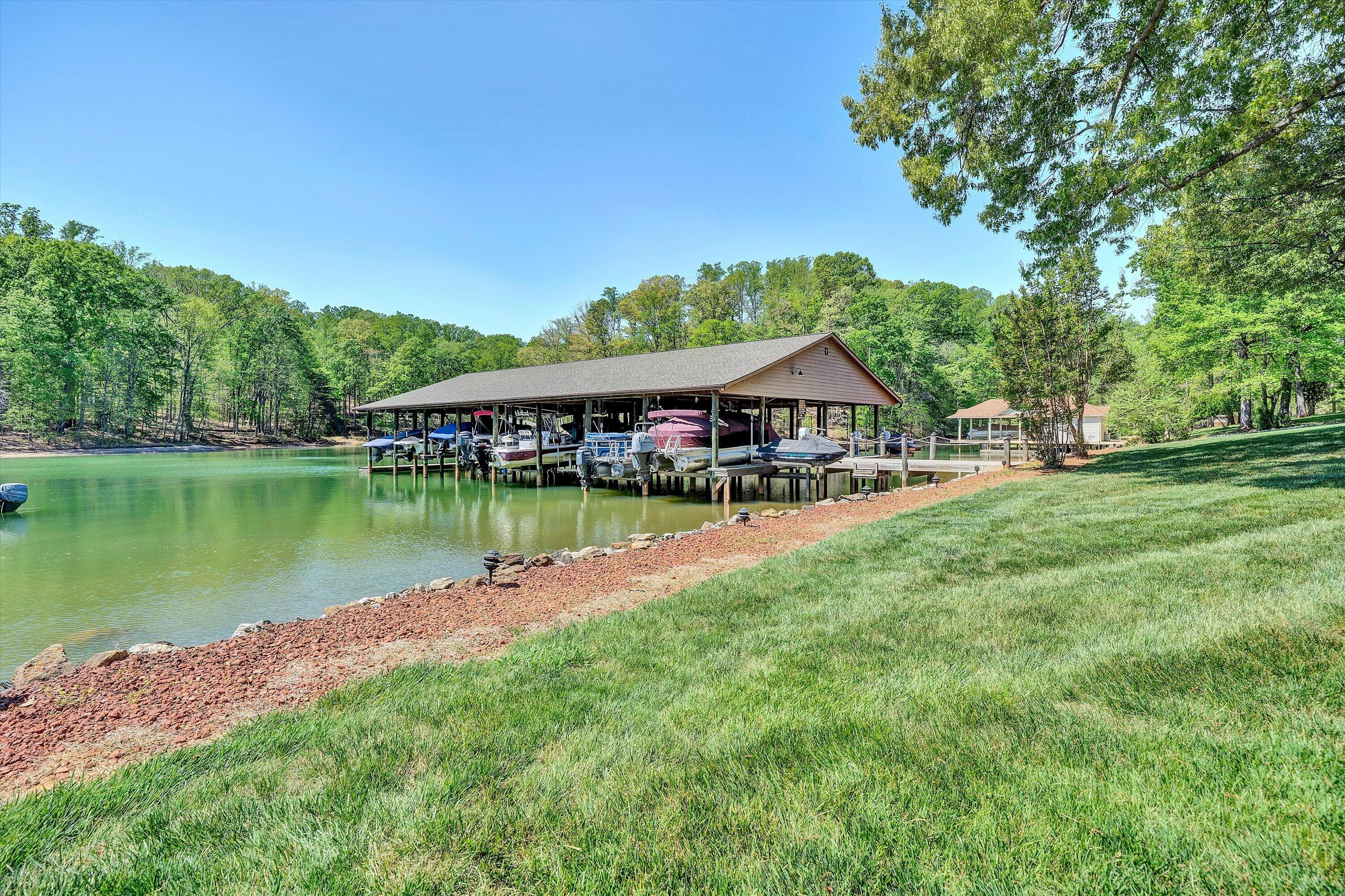 620 Monte Vista Road, Unit 605 Union Hall, VA 24176 - Photo 34 of 41 a view of a house with a garden and a lake view