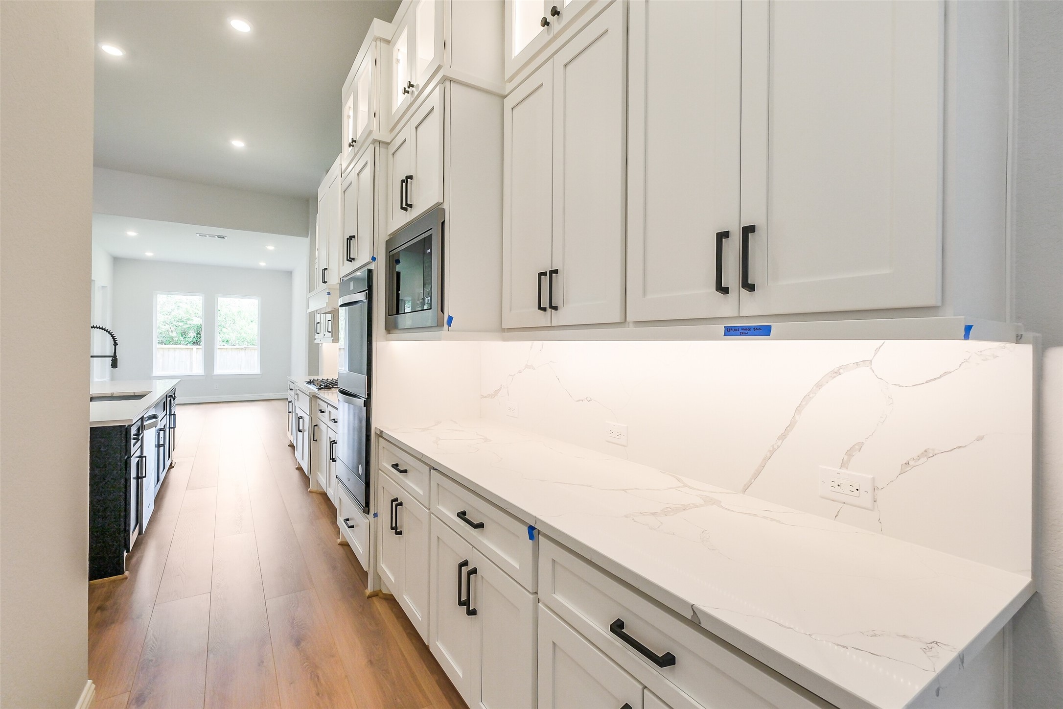 12965 Whitewater Way Conroe, TX 77302 - Photo 15 of 50 a view of a kitchen cabinets and wooden floor