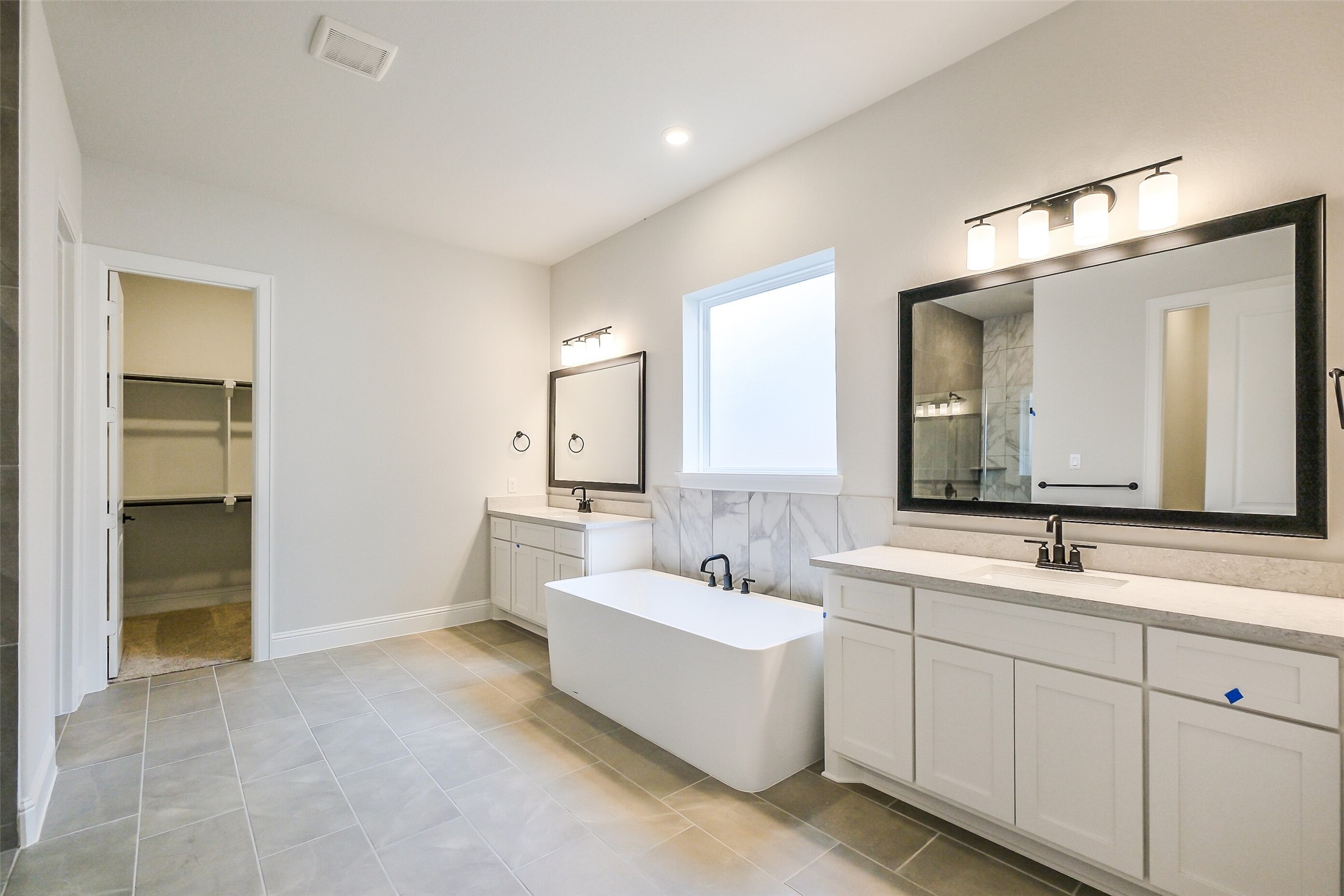 12965 Whitewater Way Conroe, TX 77302 - Photo 28 of 50 a spacious bathroom with a double vanity sink mirror and
