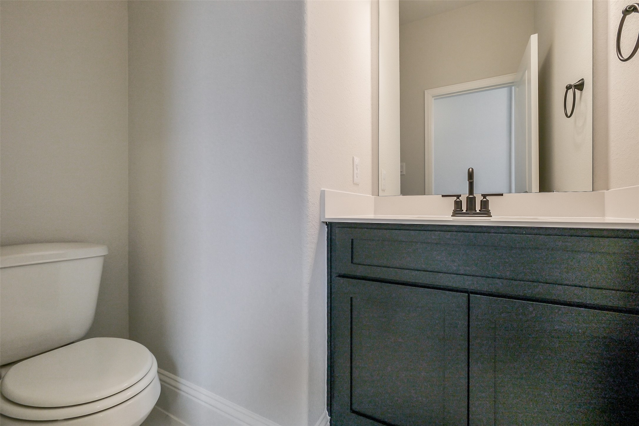 12965 Whitewater Way Conroe, TX 77302 - Photo 45 of 50 a bathroom with a toilet a sink and mirror