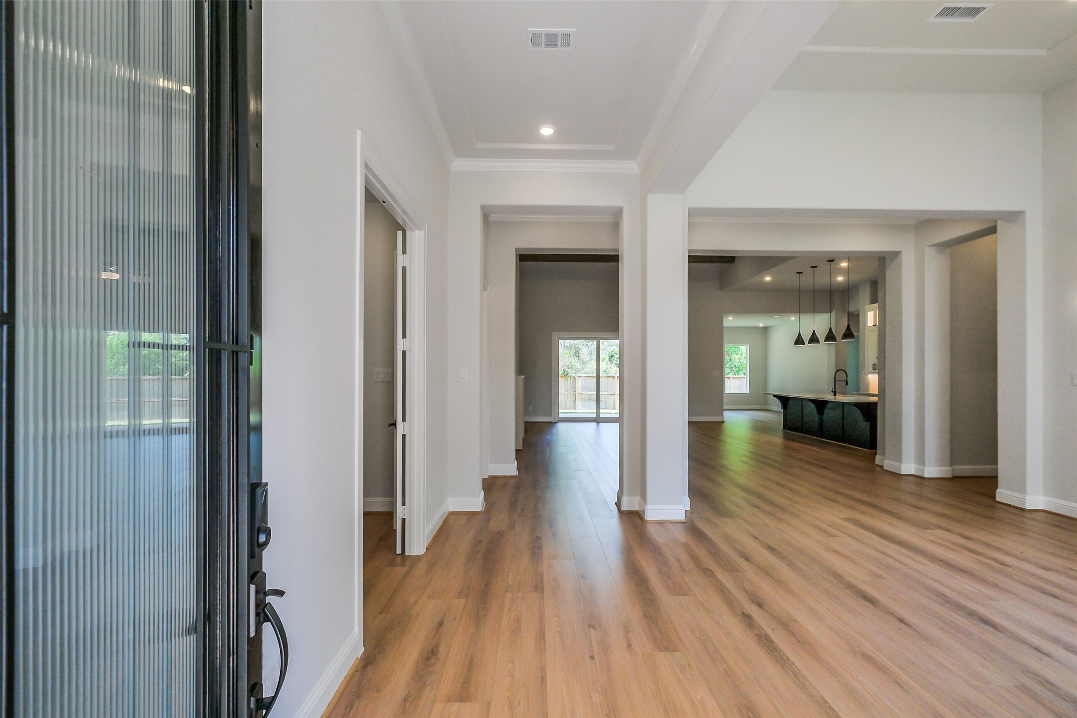 12965 Whitewater Way Conroe, TX 77302 - Photo 5 of 50 a view of a hallway with wooden floor a bathroom and a bathroom