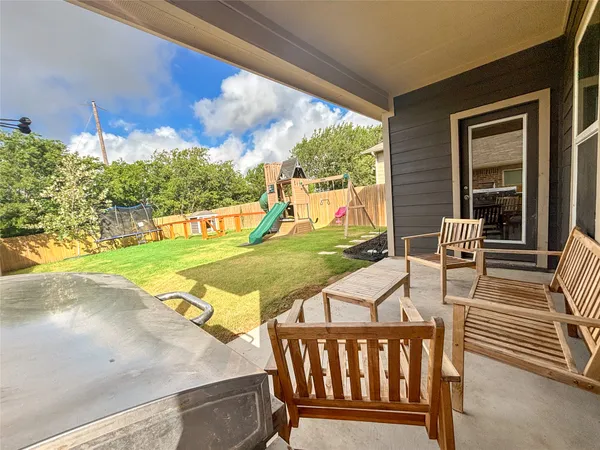 a view of a patio with a table & chairs