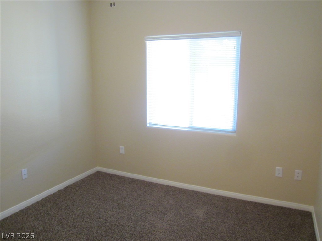 7701 West Robindale Road, Unit 262 Las Vegas, NV 89113 - Photo 14 of 26 A well-lit bedroom offering a neutral canvas for personalized decor.