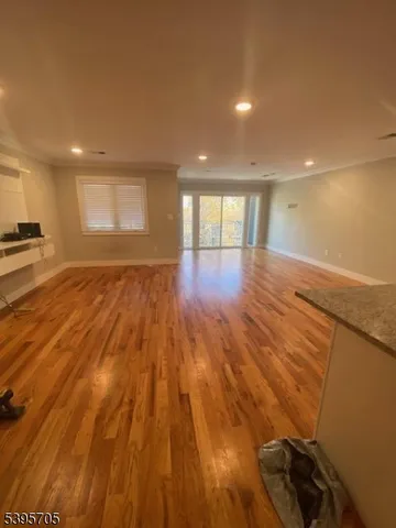 a view of an empty room and wooden floor