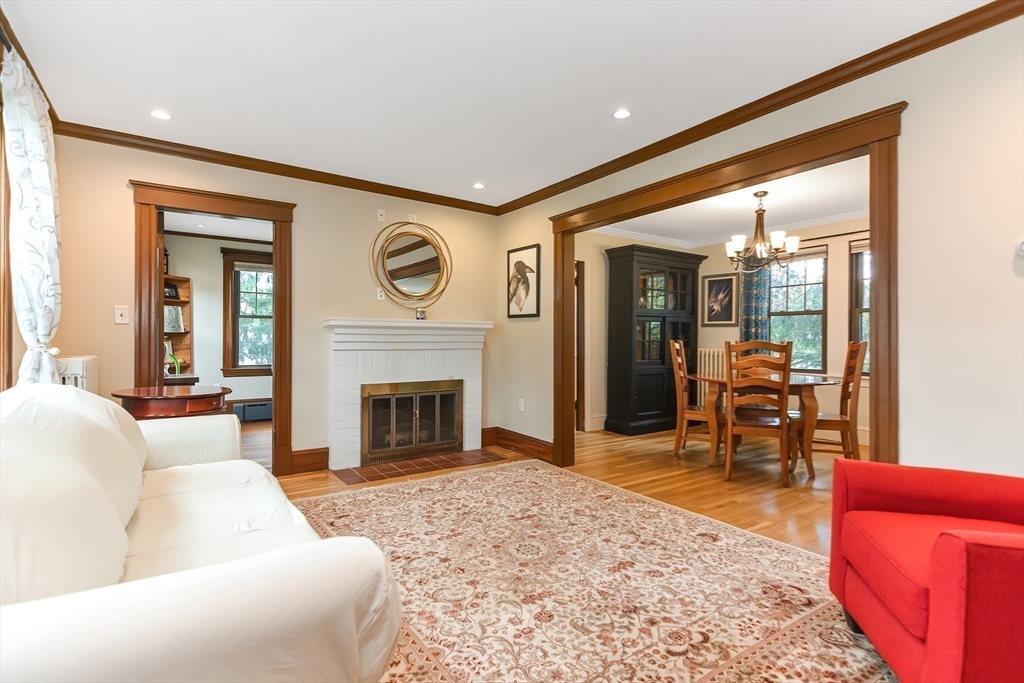 15 Evans Road Needham, MA 02492 - Photo 12 of 30 a living room with furniture a fireplace and a flat tv screen next to a window