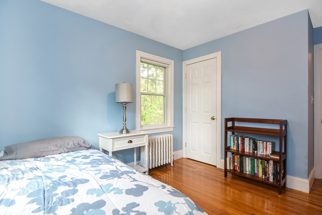 15 Evans Road Needham, MA 02492 - Photo 23 of 30 a bedroom with a bed and a book shelf