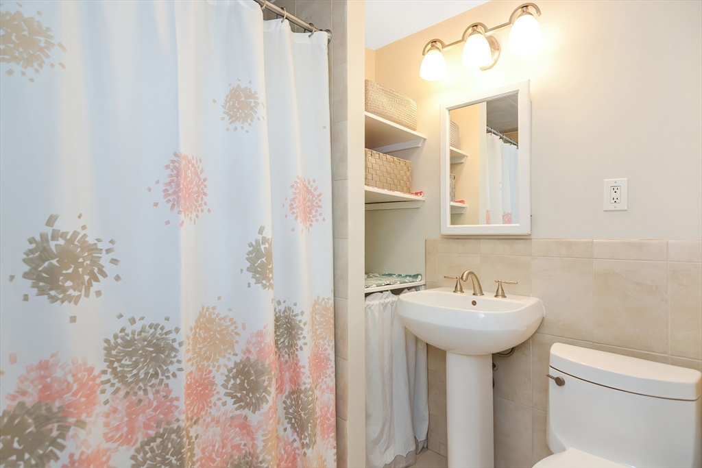 15 Evans Road Needham, MA 02492 - Photo 30 of 30 a bathroom with a sink and mirror with toilet