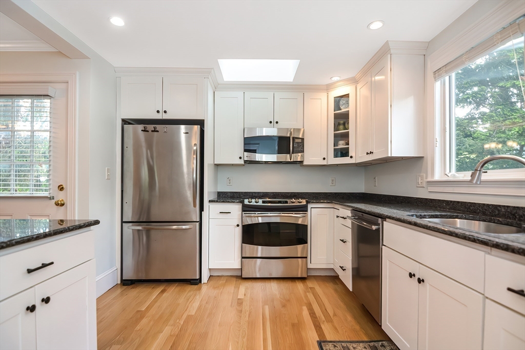 15 Evans Road Needham, MA 02492 - Photo 6 of 30 a kitchen with stainless steel appliances a refrigerator sink and microwave